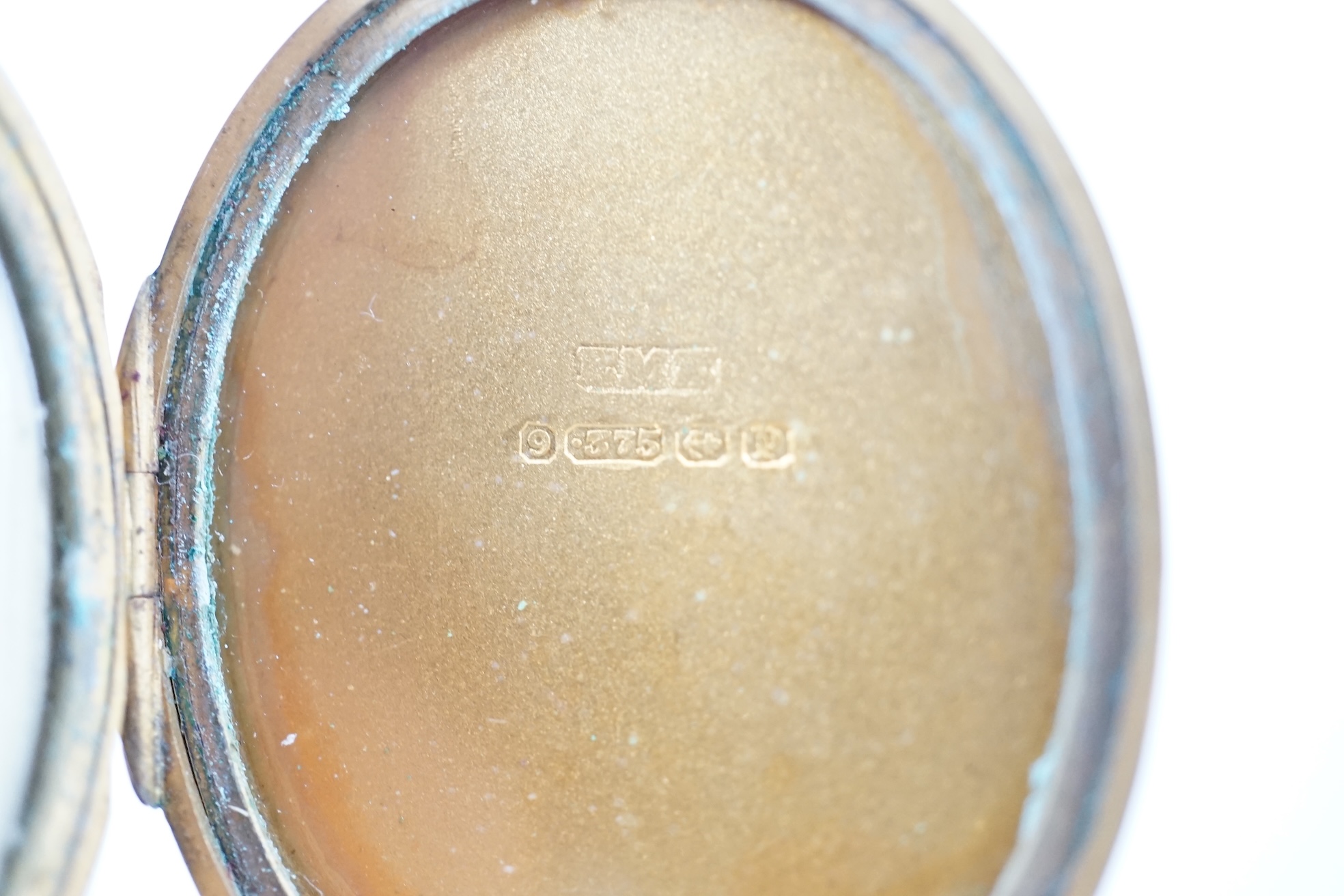 A George V engraved 9ct gold oval locket, 35mm, gross weight 11.7 grams. Condition - fair to good